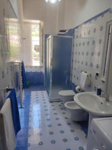 a blue and white bathroom with two toilets and a sink at Residenza Regina Margherita in Castellammare di Stabia +21 photos