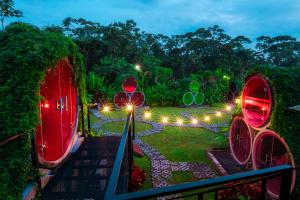 a view of a garden at night with lights at Arenal Backpackers Resort in Fortuna