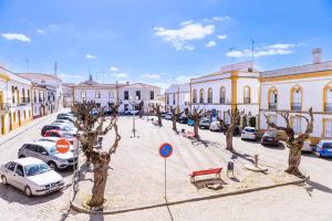 a city street with cars parked in a parking lot at Pinheiro de Monsaraz -Casas Santo António T2 in Reguengos de Monsaraz