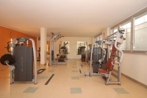 a gym with several tread machines in a room at Residence & Suites Solaf in Bonate di Sopra
