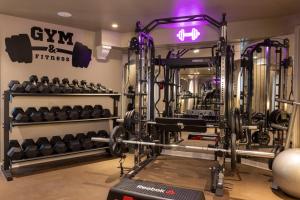 a gym with dumbbells and other equipment at Maison Cardinal Furstemberg in Paris +58 photos