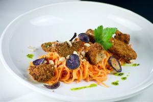 a plate of food with pasta on a white plate at Hotel Das Zeit in Lenzing