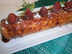 a dessert with strawberries on a plate on a table at Aux Sources de L'Ancre in Miraumont