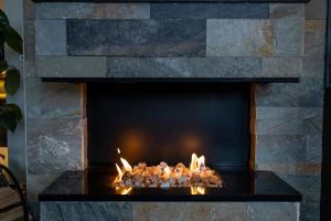 a stone fireplace with a fire in it at Dockyard Hotel in Gothenburg