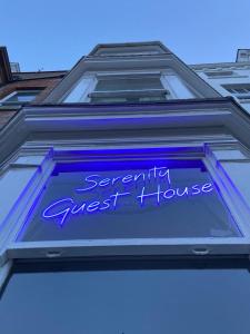 a blue sign on the side of a building at Serenity Guest House in Scarborough