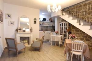 a living room with a table and chairs and a staircase at La Dimora di San Simplicio in Olbia
