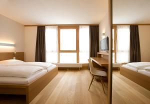 Postel nebo postele na pokoji v ubytování Hotel Manggei Designhotel Obertauern