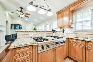 a kitchen with wooden cabinets and a stove top oven at Lb Perfect Residential Retreat in Houston