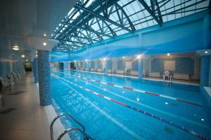 a large indoor swimming pool in a building at Gulf Stream Hotel in Kazan