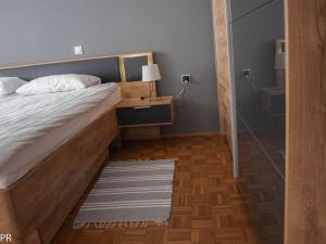a bedroom with a bed and a table with a lamp at Apartment Activity in Radomlje