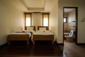 A bed or beds in a room at Thaihome Resort