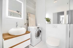 a bathroom with a washing machine and a sink at Apartament 222 stare miasto Apartamenty No 1 in Szczecin +23 photos