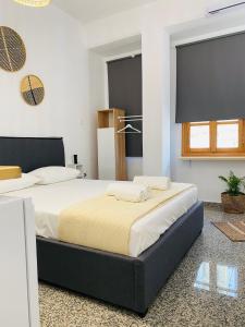 a bedroom with two beds in a room at Homdwell Fine Living 2 in Ermoupoli