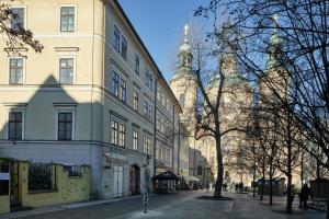 a large white building on a street with trees at Renovated Flat in Old Town Square by Prague Days in Prague