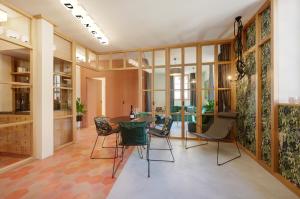 a large room with a table and chairs at Goldengel Design - Suiten im historischen Ortskern von Kaltern in Caldaro