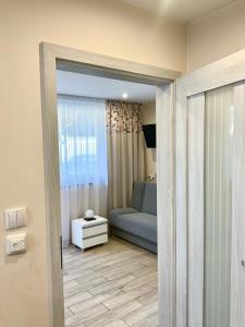 a living room with a couch and a bed at Apartamenty u Lucyny i Lecha in Łukęcin