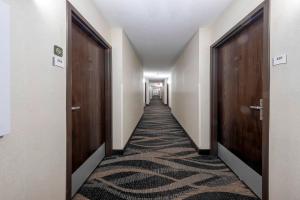 a corridor with doors and a carpeted hallway at Red Roof Inn Dahlgren - Naval Base in Dahlgren
