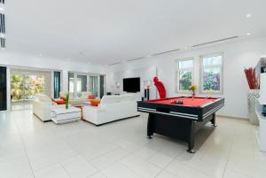 a living room with a pool table and couches at Dubai Marina Villa up 20 guest huge Private Pool in Dubai