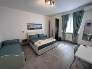 a bedroom with two beds and a table and chairs at The Pellis in Monopoli