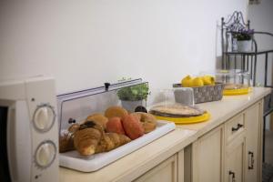 a counter with a tray of pastries and other foods at B&B I Gerani in Alghero