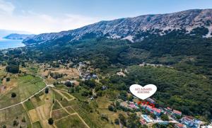 an aerial view of a heart shaped house on a mountain at KATY&MLADEN in Baška