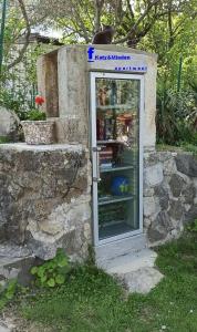 a cat sitting on top of a phone booth at KATY&MLADEN in Baška