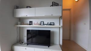 a living room with a fireplace with a flat screen tv at Apartma Coccolo in Zambratija