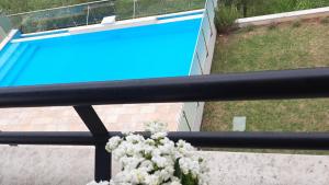 a vase of flowers sitting next to a swimming pool at Apartma Coccolo in Zambratija