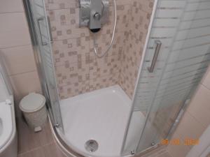 a shower with a glass door and a toilet at Corfu Old Town Gregory in Corfu Town +28 photos
