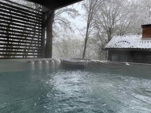 a swimming pool with snow on top of it at Irma- forrás Vendégházak in Kismaros