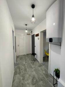 a hallway of a room with white walls and tile floors at APARTAMENT 3 camere Neptun in Neptun