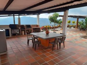 a patio with a table and chairs on a patio at Casa campestre Finca la Roca in La Mesa