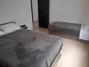 A bed or beds in a room at Casa campestre Finca la Roca