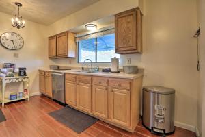 a kitchen with wooden cabinets and a sink and a window at Charming East Bernstadt Retreat Less Than 6 Acre Farm! in East Bernstadt +24 photos