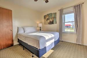 a bedroom with a large bed and a window at Charming East Bernstadt Retreat Less Than 6 Acre Farm! in East Bernstadt