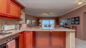a kitchen with a large island with a counter top at Seaside At 22 Sandpiper in Ballito