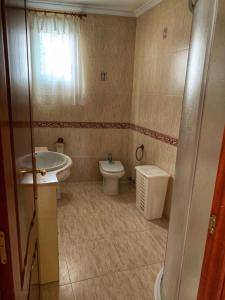 a bathroom with a toilet and a sink at Casa da Moa in O Pindo