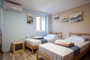 a room with two beds and a window at Hostel Adriatic Piran in Piran