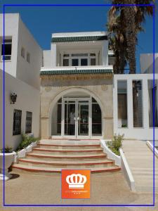 a building with steps leading up to a door at Emira Hotel in Hammamet