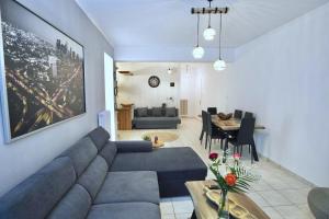 a living room with a couch and a dining room at Angelina’s Boutique Suite in Nafplio City in Nafplio