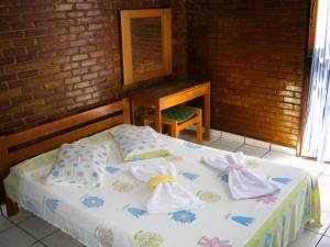 a bedroom with a bed with towels on it at Apart-Hotel Marinas da Lagoa - 2 Praias a 4 Min - in Saquarema