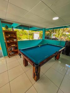 a billiard table in a room with at Pousada Orquídeas do Guarujá in Guarujá