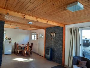 a dining room with a table and a refrigerator at Nothofagus in Caviahue