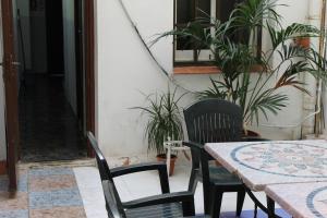 a table and chairs in a patio with plants at Central Station Hostel Barcelona in Barcelona