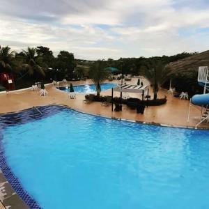 a large pool with blue water in a resort at Apartamento Caldas Novas Enseada Nautico 203c in Caldas Novas