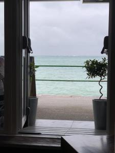 an open door with a view of the beach at Marina Metro Hotel in Saint Helier Jersey