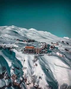 a snow covered mountain with a mountain range at Monte Hotel in Gudauri