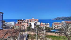 a city with buildings and the ocean in the background at Adriatique Apartments in Dobra Voda
