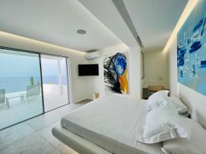 a bedroom with a bed and a view of the ocean at Villa MED in Mikonos