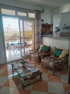 a living room with two chairs and a table at Chez Bablou in Grand-Baie